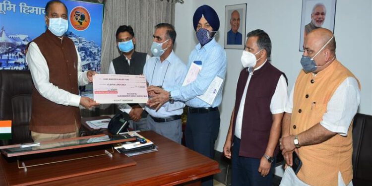 Chief Minister Jai Ram Thakur being presented a cheque of Rs. Eleven Lac by MLA Nadaun Sukhvinder Singh Sukhu towards CM relief fund at Shimla today.