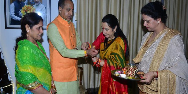 BJP Mahila Morcha members tie Rakhi on wrist of CM