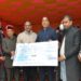 Chief Minister Jai Ram Thakur being presented a cheque of Rs. 50 lakh towards Chief Minister’s Relief Fund on behalf of Temple Trust Shri Naina Devi Ji at Kandraur in District Bilaspur today.